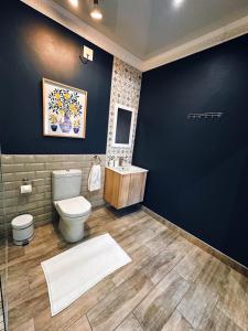 a bathroom with a toilet and a sink at Lemon & Blue in Welkom