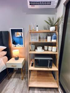 a room with a shelf with a microwave on it at Lemon & Blue in Welkom +8 photos