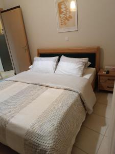 a bed with white sheets and pillows in a bedroom at ELIA Guesthouse in Komotini +17 photos