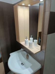 a bathroom with a sink and a mirror at ELIA Guesthouse in Komotini