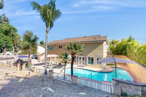 a house with a swimming pool in front of a house at Rancho Retreat in Rancho Cucamonga
