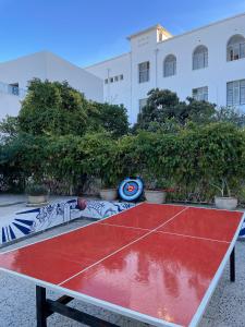 a ping pong table in front of a building at Nomads Hostel Tunisia in Tunis +37 photos