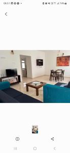 a living room with two blue couches and a table at Two room flat in colombo 5 in Narahenpita