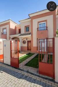 a house with a red gate in front of it at Villa Marquesado in Dos Hermanas