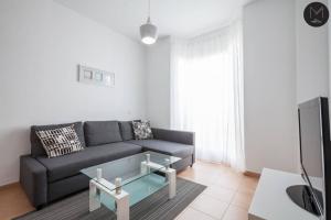 a living room with a couch and a table at Villa Marquesado in Dos Hermanas