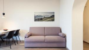 a living room with a couch and a table at Apartments Hofgarten in Caldaro +39 photos