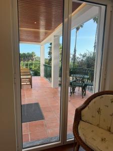 a screened in porch with sliding glass doors at Quinta Verde Sintra - Casa de Campo in Sintra