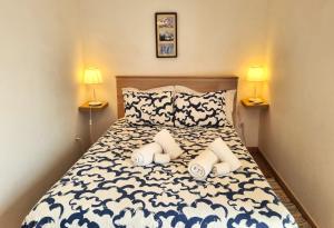 a small bedroom with a bed with two lamps at HAUS NUNES by Stay in Alentejo in Vila Nova de Milfontes +88 photos