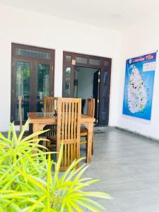 a wooden table and chairs on a patio at Fanisha Family Villa and Restaurant in Negombo