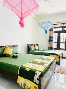 a bedroom with two beds and a couch at Fanisha Family Villa and Restaurant in Negombo +45 photos