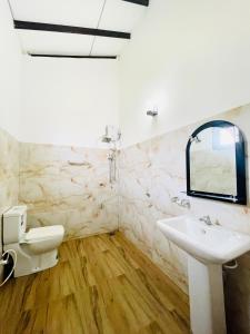 a bathroom with a sink and a mirror at Fanisha Family Villa and Restaurant in Negombo