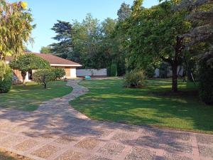 a walkway in a yard with a house at CHACRAS Land in Ciudad Lujan de Cuyo +9 photos