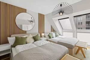 a bedroom with two beds and a mirror at Fast Wifi I 3 min walk to Metro I On-Site Parking for 19,90 Eur in Vienna