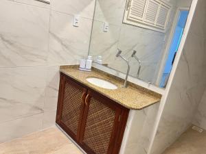 a bathroom with a sink and a mirror at Praia Marina Suite - Morro Branco in Beberibe