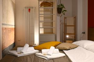 a bedroom with a bed with towels on it at La Casa di Apollo in Naples