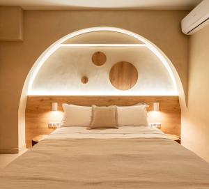 a bedroom with a large bed with an arch above it at Gaia Nest in Piraeus