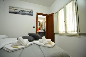 a bedroom with two white towels on a bed at La Casa di Apollo in Naples +85 photos