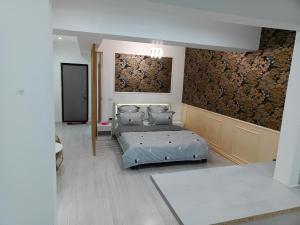 a bedroom with two beds and a flat screen tv at Lumière Lounge in Craiova +4 photos