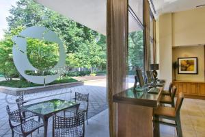a dining room with a table and chairs and a large window at Cozy 2 BR Apartment At Arlington With Gym in Arlington