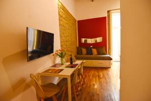 a living room with a table and a couch at La Casa di Apollo in Naples