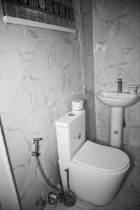 a bathroom with a toilet and a sink at Mclanraysterlin in Lagos Island
