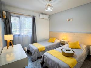 Ένα ή περισσότερα κρεβάτια σε δωμάτιο στο Hotel Alta Mendoza +63 φωτογραφίες