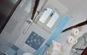 a bathroom with a shower and a toilet and a window at Casa Barbara in Amalfi +101 photos