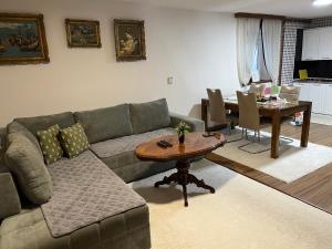 a living room with a couch and a table at Apartman House Jasmina in Bihać
