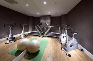 a gym with treadmills and exercise bikes in a room at Eurostars Thalia in Prague