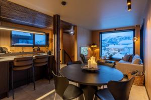 a kitchen and living room with a table and chairs at Aurora Escape in Tromsø