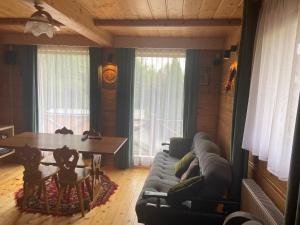 a living room with a couch and a table at Domek w górach in Nowy Targ