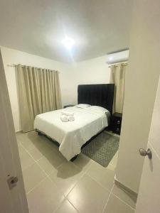 a bedroom with a bed with two wedding rings on it at Modern and Cozy 3-Bedroom Apartment in Santo Domingo in Los Paredones