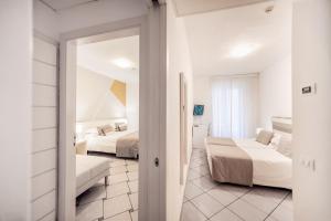 a hotel room with two beds and a couch at Hotel Rivage in Sorrento