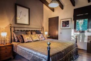 a bedroom with a bed and a clock on the wall at Villa Palmera in Olivella +9 photos