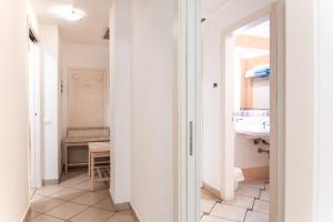 a hallway with a bathroom and a sink at Hotel Rivage in Sorrento