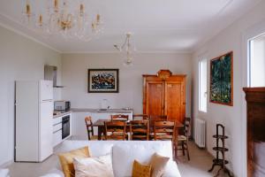 a kitchen and dining room with a couch and a table at Residenza Salvia CASA GUARNONE in Mornico Losana