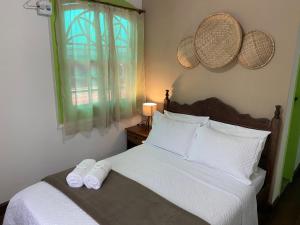 Postel nebo postele na pokoji v ubytování Casa Coco Verde Paraty