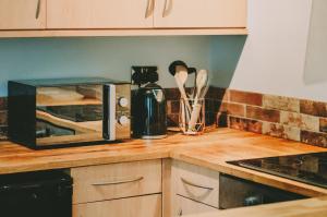a kitchen counter with a toaster oven and a microwave at The Black Isle Retreat in Inverness