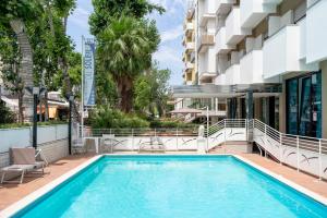 a swimming pool on the side of a building at Hotel Du Soleil in Rimini