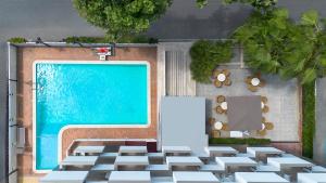 a painting of a swimming pool next to a wall at Hotel Du Soleil in Rimini