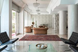 a living room with two chairs and a couch at Hotel Du Soleil in Rimini