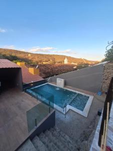 a swimming pool on the roof of a house at Pousada Lua Rosa in Piranhas