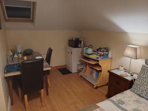 a small room with a desk and a kitchen with a table at Country Haven eircode H54 AK31 in Galway