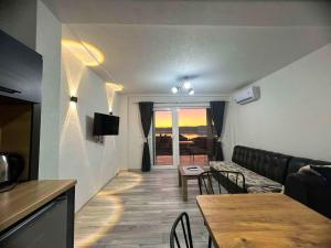 a living room with a couch and a table at Apartments Sunset Jovanoski in Ohrid