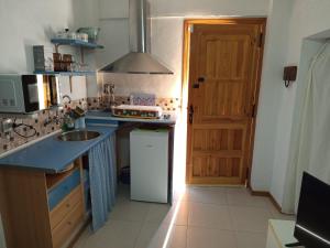 a kitchen with a sink and a counter top at La Pequeña Parrita in Guadalcanal