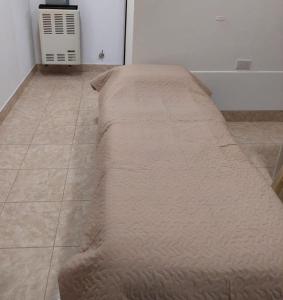 a couch sitting on the floor in a room at Lauquen in Puerto Deseado +8 photos