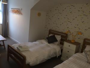 a bedroom with a bed and a desk at Portreath Arms in Portreath