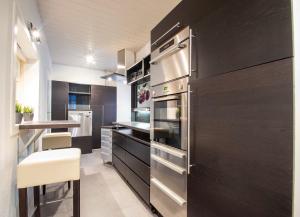 a kitchen with a stainless steel oven and a counter at AHOI HOMES Royal Living - Innenstadt - Parkplatz in Flensburg +14 photos