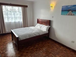 Postel nebo postele na pokoji v ubytování Milimani Guesthouse