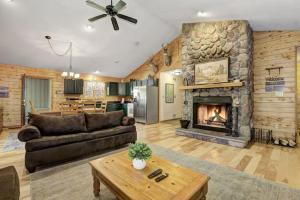 a living room with a couch and a fireplace at Woodland Cabin Getaway in Greentown